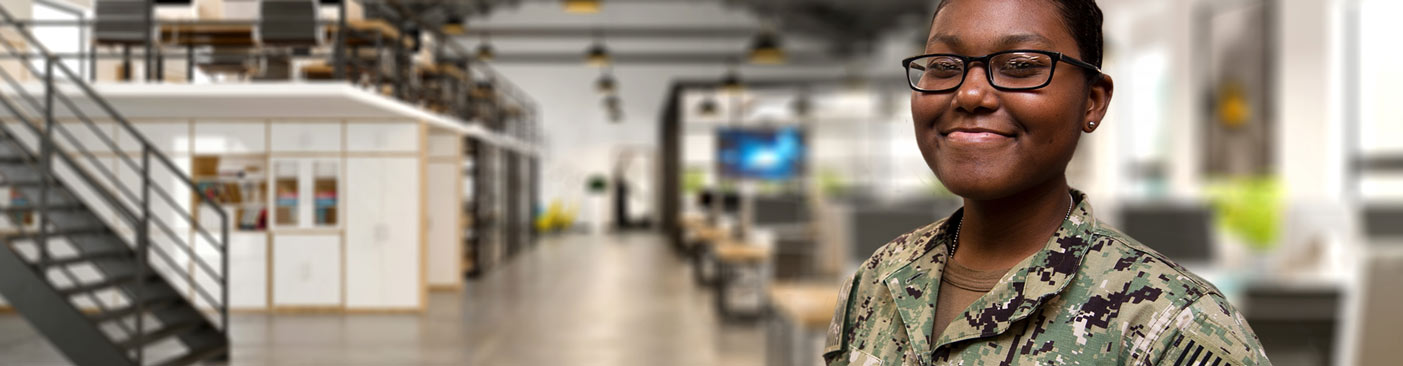 Soldier smiling in front of open office